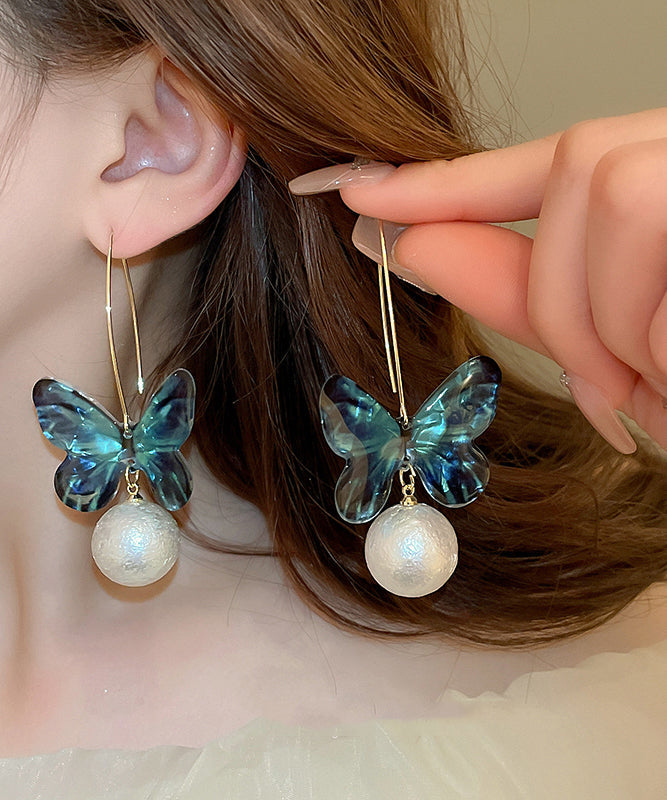 Boucles d'oreilles créoles en acrylique bleu avec perles et papillon - Street-Wave