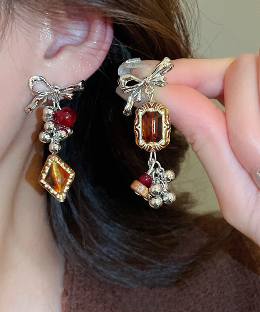 Boucles d'oreilles pendantes vintage asymétriques en alliage acrylique avec nœud ambré et pompon - Street-Wave