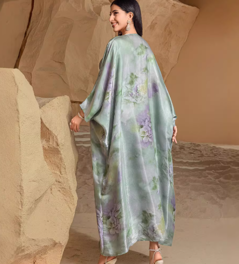 Elegant holiday dress with green fruit print and batwing sleeves