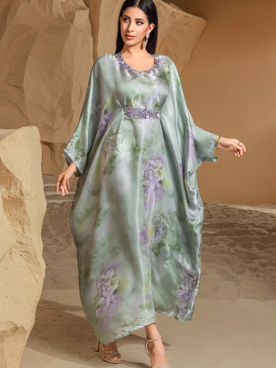 Elegant holiday dress with green fruit print and batwing sleeves